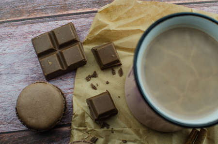 Cocoa drink with spices, zephyr and macaroons on wooden backgroundの写真素材
