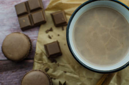 Cocoa drink with spices, zephyr and macaroons on wooden backgroundの写真素材