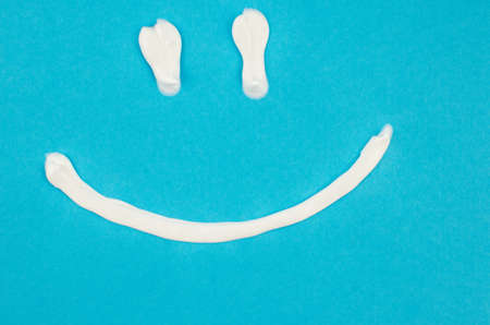 toothpaste and brush on a blue background with place for text. Health, cleanliness and beautyの写真素材