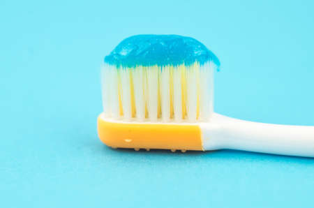 toothpaste and brush on a blue background with place for text. Health, cleanliness and beautyの写真素材
