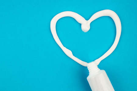 toothpaste and brush on a blue background with place for text. Health, cleanliness and beautyの写真素材