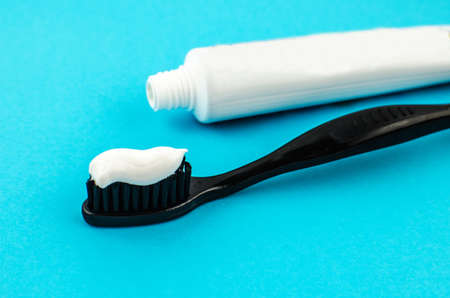 toothpaste and brush on a blue background with place for text. Health, cleanliness and beautyの写真素材