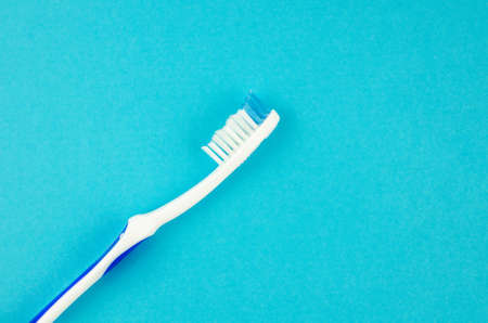 toothpaste and brush on a blue background with place for text. Health, cleanliness and beautyの写真素材