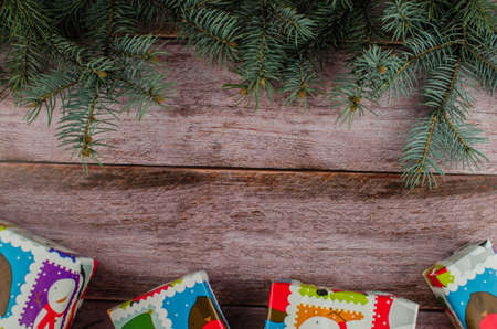 Gift boxes with a large red bow against a background bokeh of twinkling party lights. Luxury New Year gift. Christmas gift. Christmas background with gift box. Christmastime celebration. Copy space to text.の写真素材