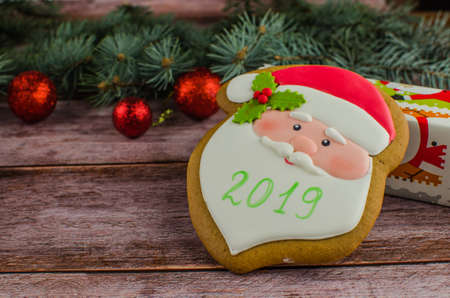 Gift boxes with a large red bow against a background bokeh of twinkling party lights. Luxury New Year gift. Christmas gift. Christmas background with gift box. Christmastime celebration. Copy space to text.の写真素材