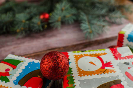 Gift boxes with a large red bow against a background bokeh of twinkling party lights. Luxury New Year gift. Christmas gift. Christmas background with gift box. Christmastime celebration. Copy space to text.の写真素材