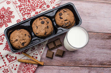freshly baked chocolate chip cookies on rustic wooden table. Copy space for textの写真素材
