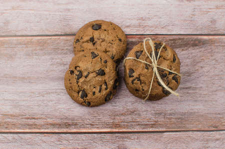 freshly baked chocolate chip cookies on rustic wooden table. Copy space for textの写真素材
