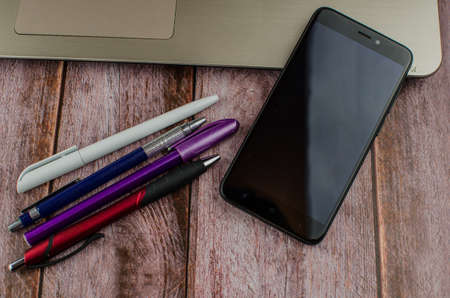 Pen and notebook on laptop. Copy space for textの写真素材
