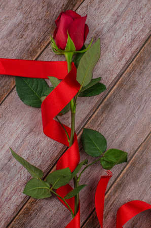 Red rose and Valentines day hearts on wood. copy space for textの写真素材