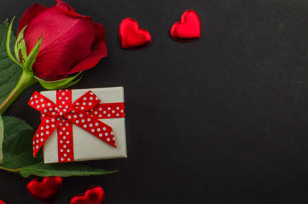 Red rose and Valentines day hearts on wood. Top view with copy spaceの写真素材