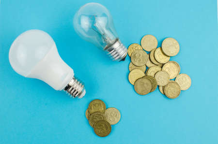 incandescent lamp and energy saving on a blue background. Copy spaceの写真素材