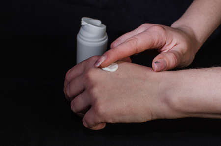 Smear cream on woman hand. Lotion for face or body.の写真素材