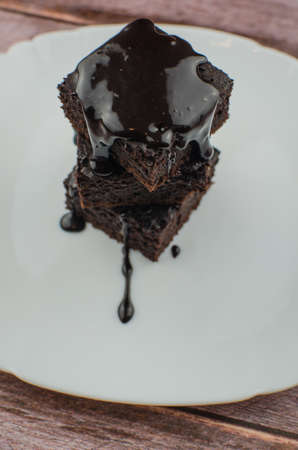 Sliced homemade brownies on white plate. Served on rectangle white plate. Favorite chocolate dessert for chocolate lover. Sweet and moist of cocoa taste.の写真素材