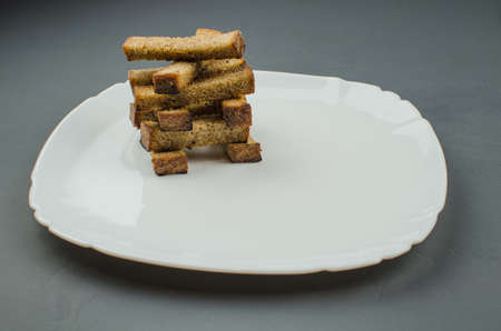 Toasts are fried on a frying pan with spices. Served on a white plate with garlic sauceの写真素材