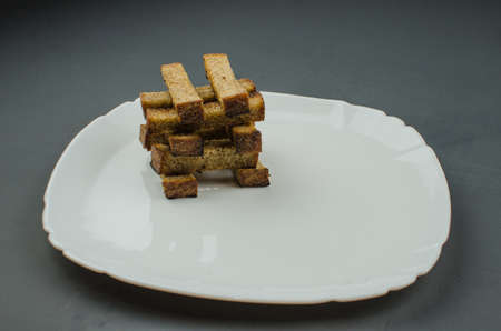 Toasts are fried on a frying pan with spices. Served on a white plate with garlic sauceの写真素材