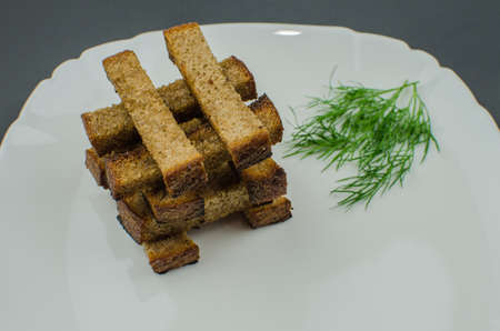 Toasts are fried on a frying pan with spices. Served on a white plate with garlic sauceの写真素材