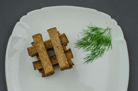 Toasts are fried on a frying pan with spices. Served on a white plate with garlic sauceの写真素材