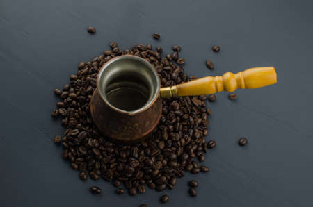 Turkish or Greek Coffee in heart shaped roasted coffee beans on white rustic wooden table from top view.の写真素材