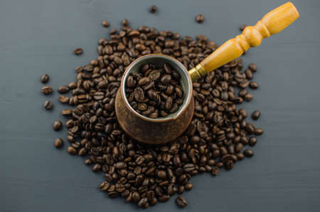 Turkish or Greek Coffee in heart shaped roasted coffee beans on white rustic wooden table from top view.の写真素材