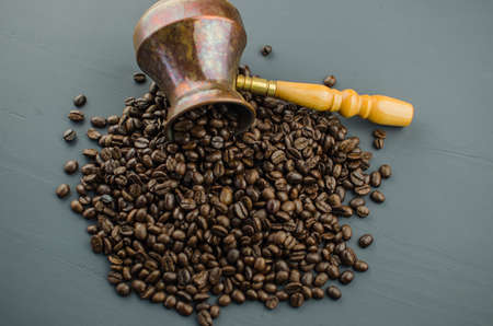 Turkish or Greek Coffee in heart shaped roasted coffee beans on white rustic wooden table from top view.の写真素材