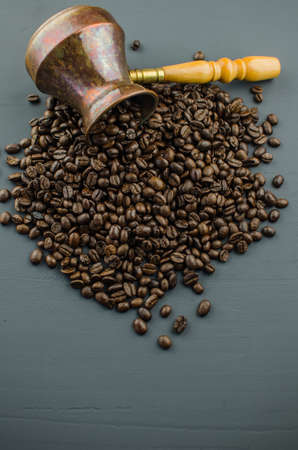 Turkish or Greek Coffee in heart shaped roasted coffee beans on white rustic wooden table from top view.の写真素材