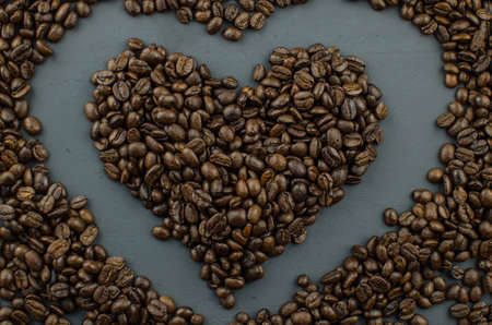Turkish or Greek Coffee in heart shaped roasted coffee beans on white rustic wooden table from top view.の写真素材