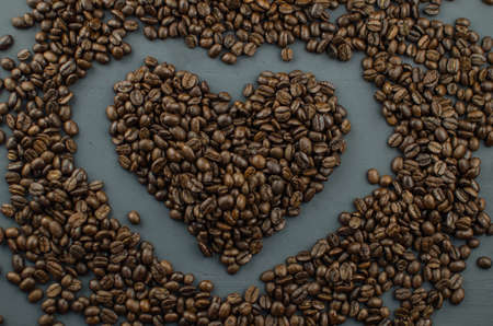 Turkish or Greek Coffee in heart shaped roasted coffee beans on white rustic wooden table from top view.の写真素材
