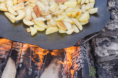 Fresh potato boiled in large restaurant frying pan. Picnic healthy food cooking at large metallic pan. fresh airの写真素材