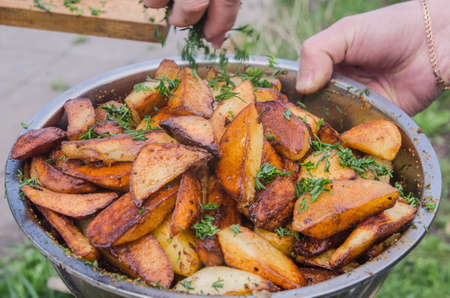 Fresh potato boiled in large restaurant frying pan. Picnic healthy food cooking at large metallic pan. fresh airの写真素材