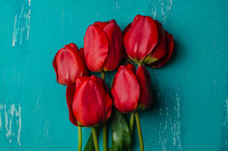 Bouquet of pink tulips on a blue wooden background. View from above.の写真素材