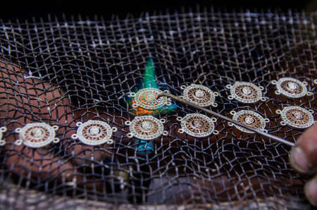 Attacking gold on a silver jewelry. Jewelery workの写真素材