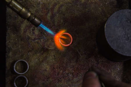 Craft jewelery making with professional tools. A handmade jeweler process, manufacture of jewellery. Melting metalの写真素材