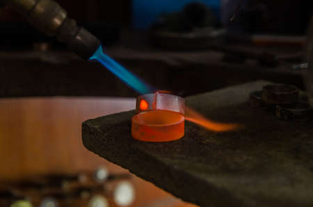 Craft jewelery making with professional tools. A handmade jeweler process, manufacture of jewellery. Melting metalの写真素材