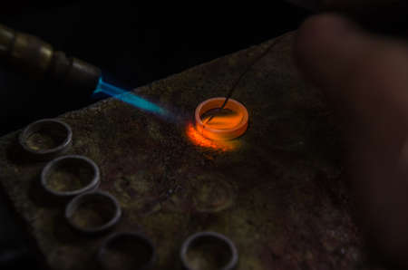 Craft jewelery making with professional tools. A handmade jeweler process, manufacture of jewellery. Melting metalの写真素材