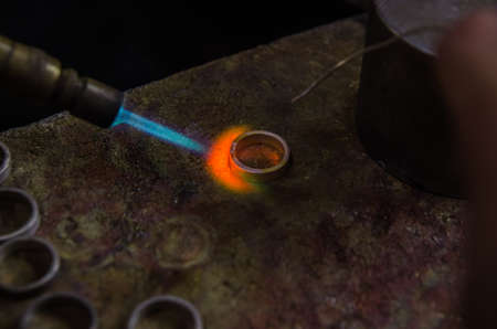 Craft jewelery making with professional tools. A handmade jeweler process, manufacture of jewellery. Melting metalの写真素材