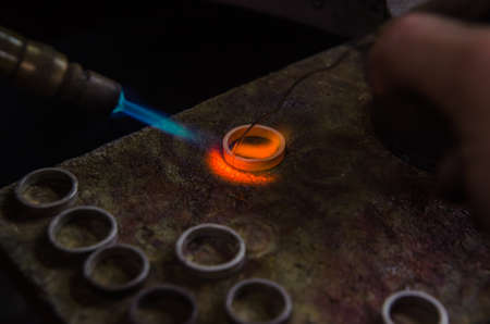 Craft jewelery making with professional tools. A handmade jeweler process, manufacture of jewellery. Melting metalの写真素材
