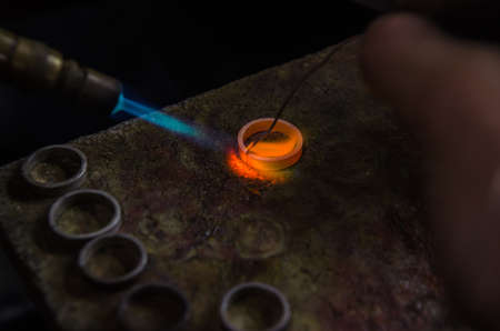 Craft jewelery making with professional tools. A handmade jeweler process, manufacture of jewellery. Melting metalの写真素材