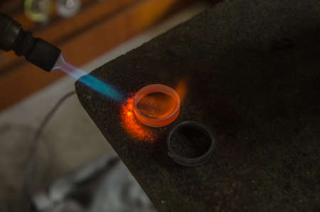 Craft jewelery making with professional tools. A handmade jeweler process, manufacture of jewellery. Melting metalの写真素材