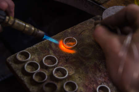 Craft jewelery making with professional tools. A handmade jeweler process, manufacture of jewellery. Melting metalの写真素材
