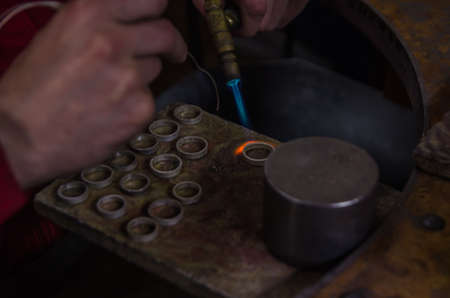 Craft jewelery making with professional tools. A handmade jeweler process, manufacture of jewellery. Melting metalの写真素材