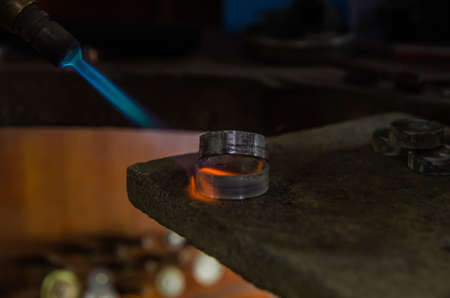 Craft jewelery making with professional tools. A handmade jeweler process, manufacture of jewellery. Melting metalの写真素材