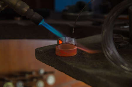 Craft jewelery making with professional tools. A handmade jeweler process, manufacture of jewellery. Melting metalの写真素材