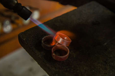 Craft jewelery making with professional tools. A handmade jeweler process, manufacture of jewellery. Melting metalの写真素材