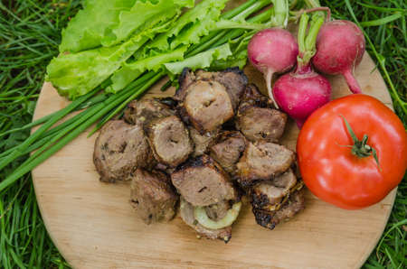 shashlik with vegetables on wooden backgroundの写真素材