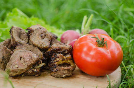 shashlik with vegetables on wooden backgroundの写真素材
