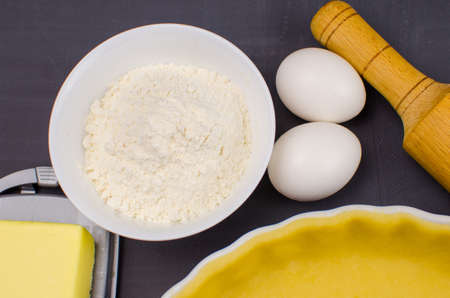 shortbread dough for baking quiche tart and ingredients in baking formの写真素材