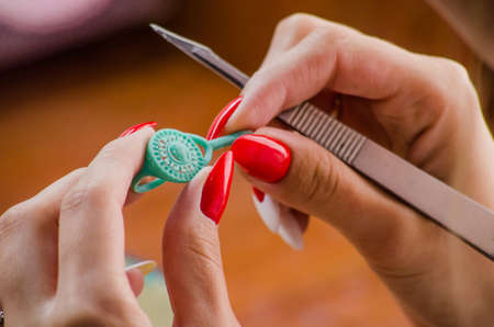 Jeweler working with wax model ring in his workshop.の写真素材