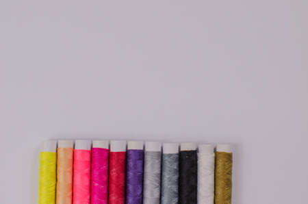 Multi-colored threads in spools, sewing kit, tailor's kit on a light background.の写真素材
