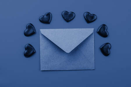 Valentine's day.Envelope with red hearts on Brown wooden background.の写真素材